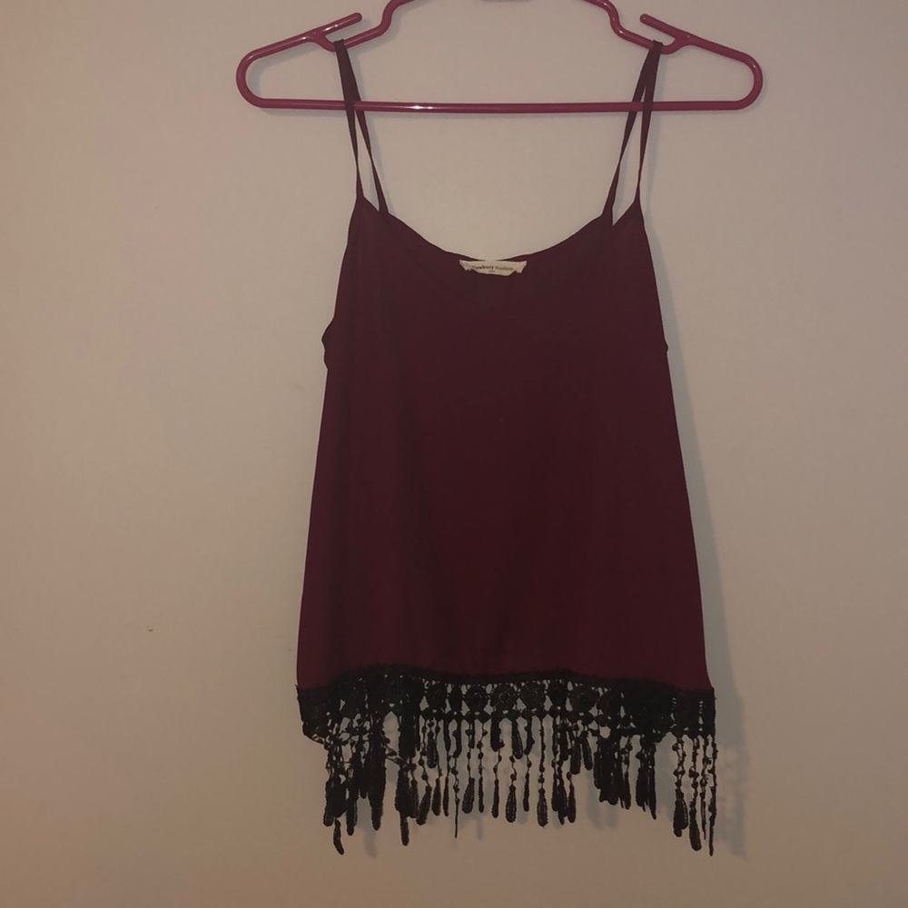 1 burgundy tank with black ruffles at the bottom